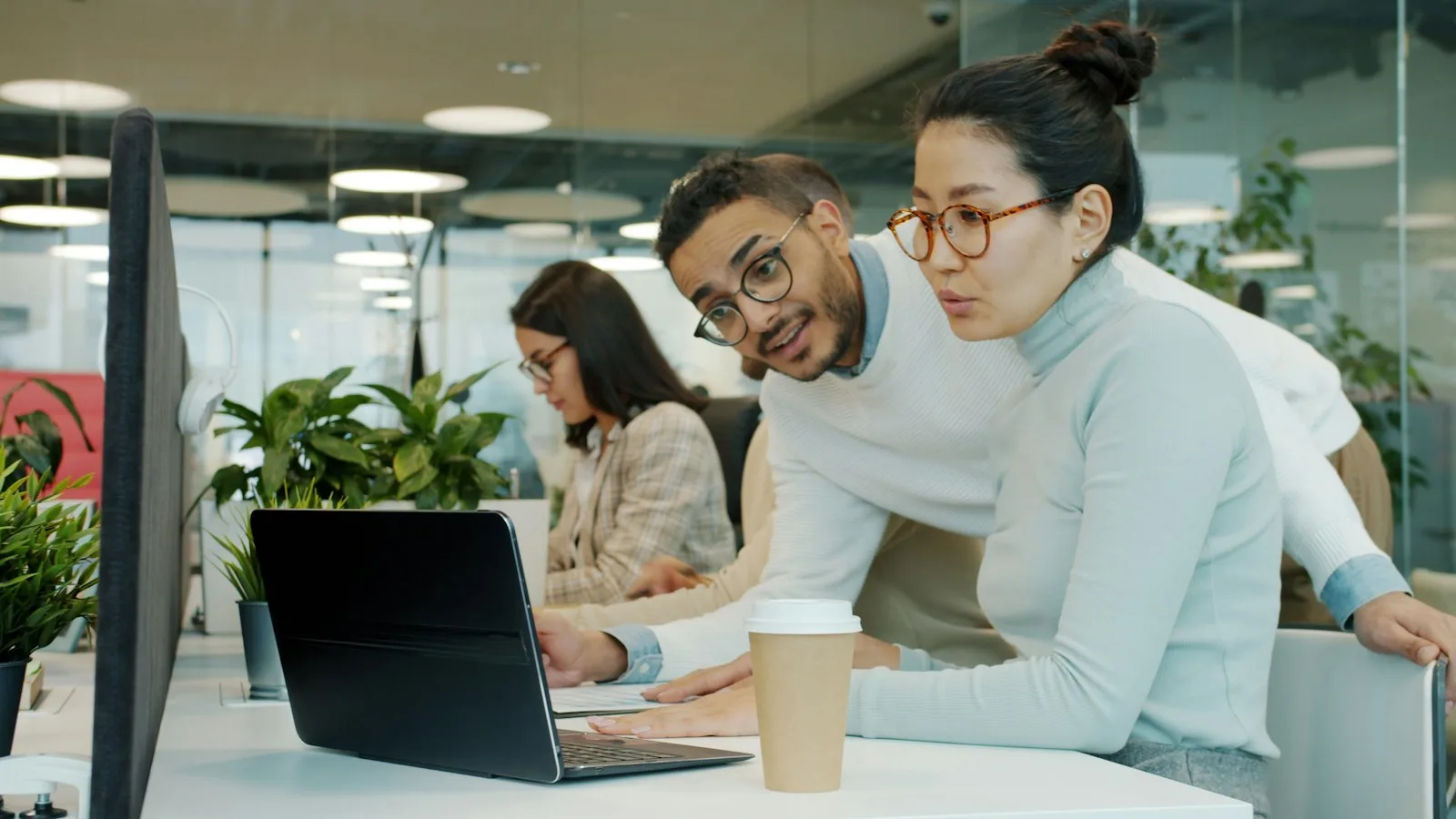 Two itinerary planners reviewing a route together on a laptop